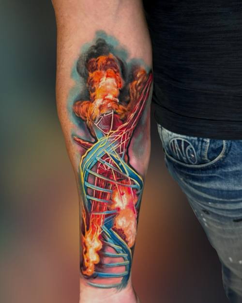 Surreal color DNA double helix with flames on the forearm by Padre at KAZENTATTOO, Los Angeles