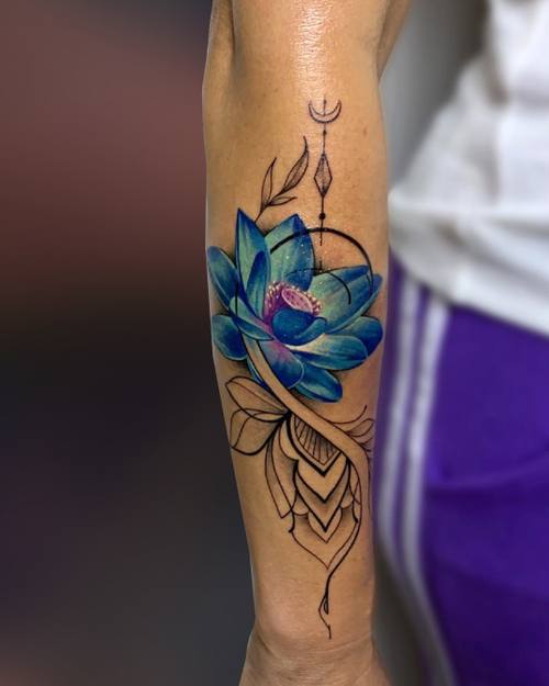 Color blue lotus with fine line ornamental details on the forearm by Padre at KAZENTATTOO, Los Angeles