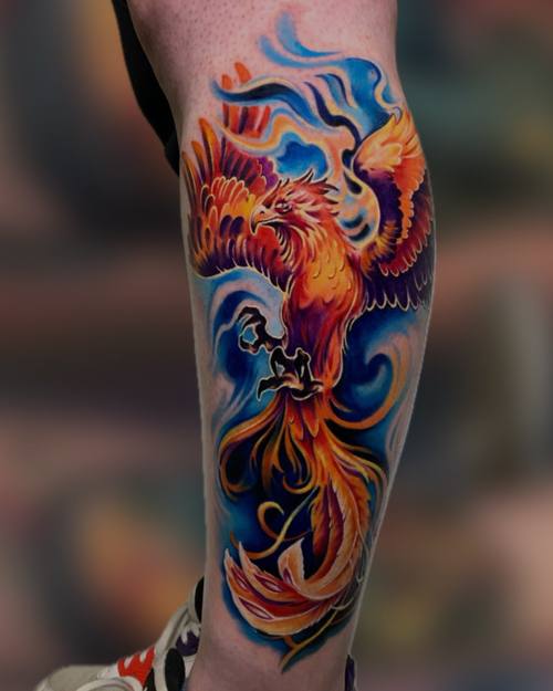 Bright phoenix in swirling blue, orange and red on the calf by Padre at KAZENTATTOO, Los Angeles
