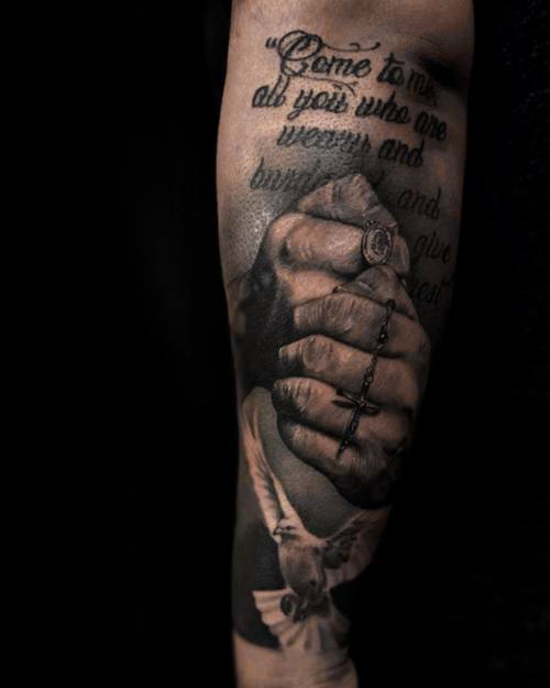 Clasped hands with a rosary and lettering, black and grey forearm tattoo by Sam at KAZENTATTOO, Los Angeles