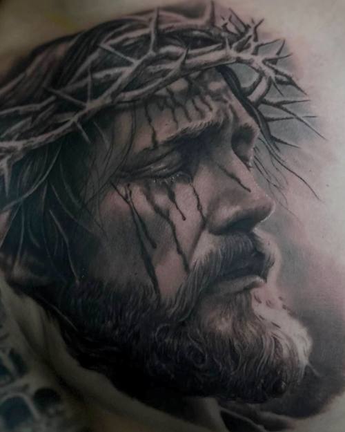 Jesus with the crown of thorns in profile, black and grey realism arm tattoo by Sam at KAZENTATTOO, Los Angeles