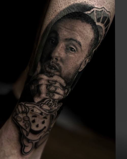 Man's portrait with a raised hand, black and grey realism forearm tattoo by Sam at KAZENTATTOO, Los Angeles