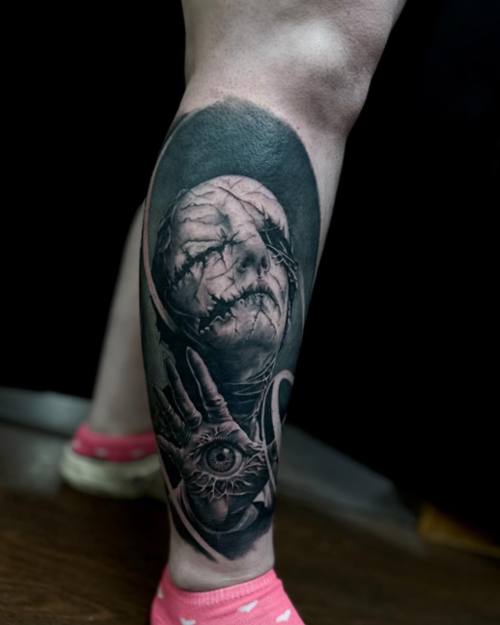 Stitched horror face with an eye in the palm, black and grey calf tattoo by Sam at KAZENTATTOO, Los Angeles, second view