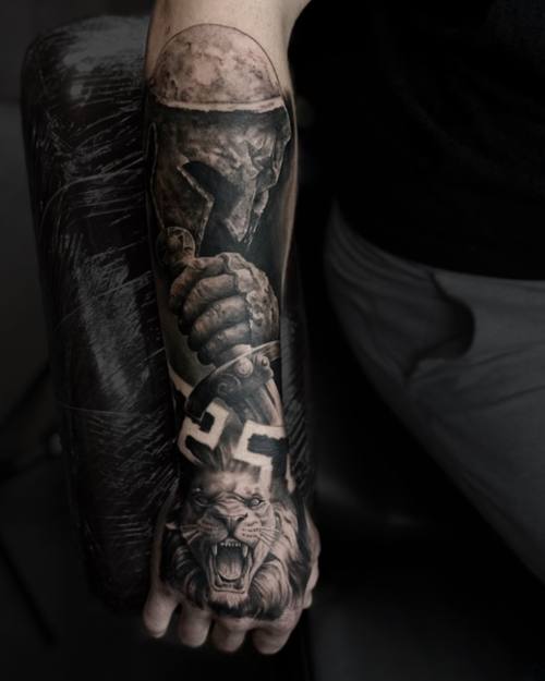Armoured fist with a horned creature, dark black and grey forearm sleeve by Sam at KAZENTATTOO, Los Angeles