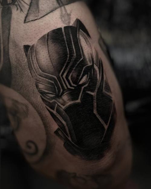 Black panther mask, black and grey realism thigh tattoo by Sam at KAZENTATTOO, Los Angeles
