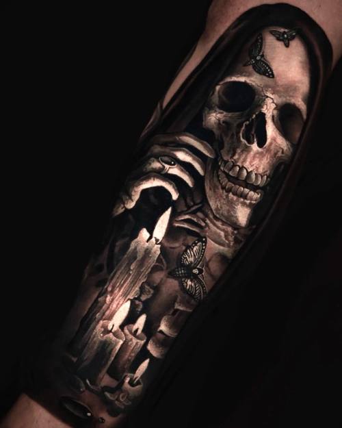 Reaper skull with burning candles, black and grey forearm tattoo