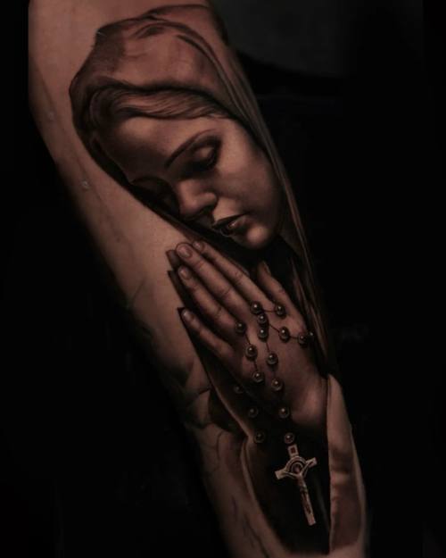 Virgin Mary praying with rosary, black and grey realism forearm tattoo by Vladimir Kozachenko