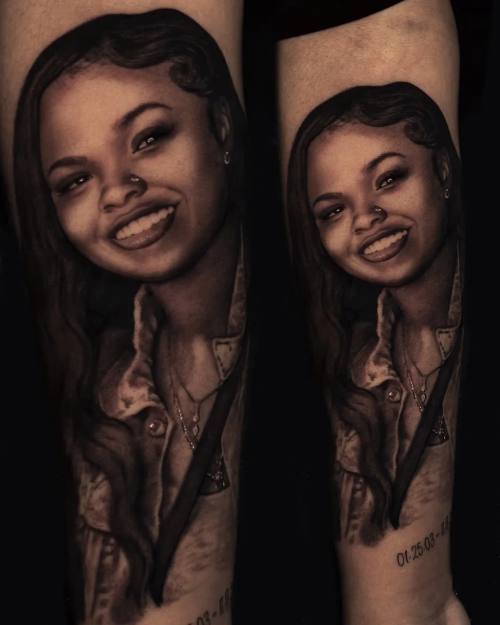 Portrait of a smiling young woman with lettering, black and grey forearm tattoo by Vladimir Kozachenko