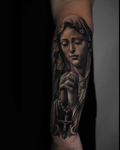 Virgin Mary praying with rosary and crucifix, black and grey forearm tattoo by Vladimir Kozachenko