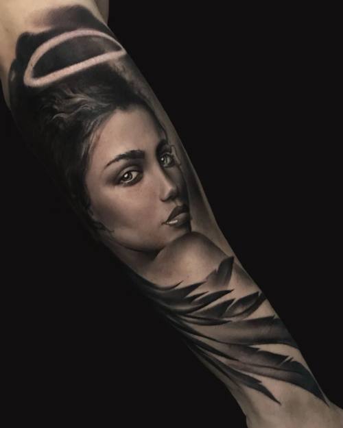 Woman portrait in a hood, black and grey realism arm tattoo by Vladimir Kozachenko