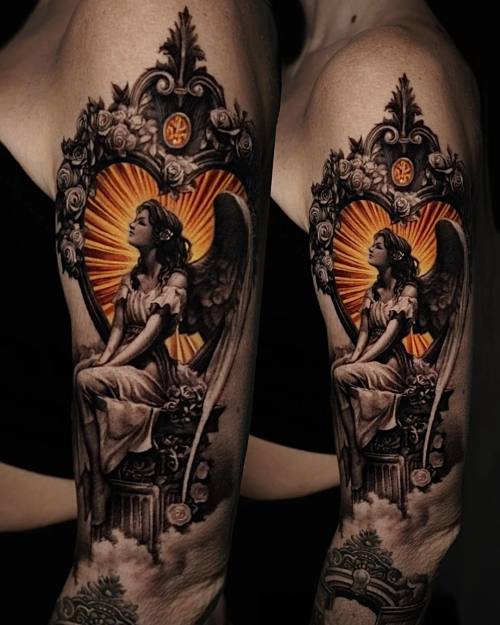 Winged angel in a heart frame with roses, upper arm tattoo