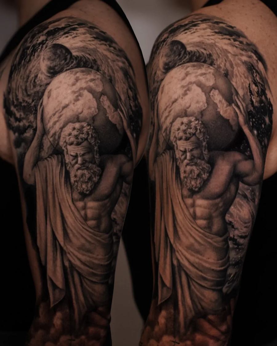 Classical statues in flowing robes, black and grey upper arm tattoo by Vladimir Kozachenko at KAZENTATTOO, Los Angeles