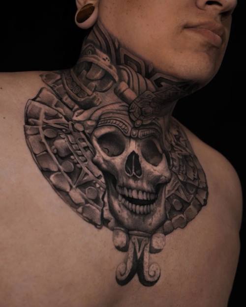 Aztec skull with stone calendar ornament, neck and chest tattoo