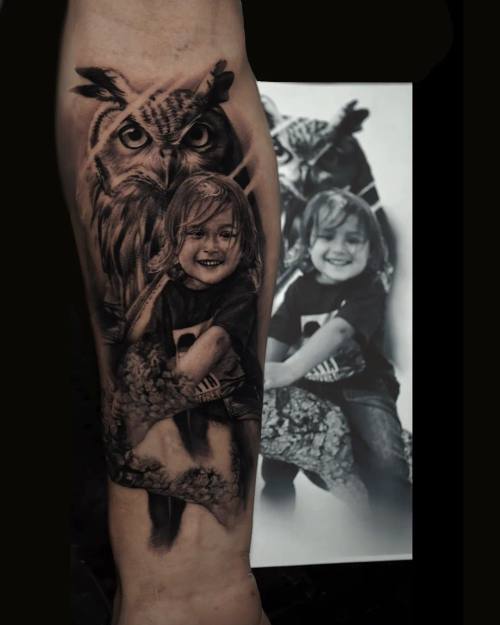 Owl with a child portrait, black and grey realism arm tattoo by Vladimir Kozachenko